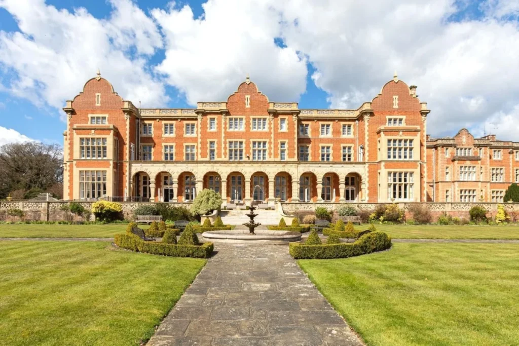 Easthampstead Park, a Grade II listed Victorian country house wedding and event venue in Berkshire, seen across its lawns