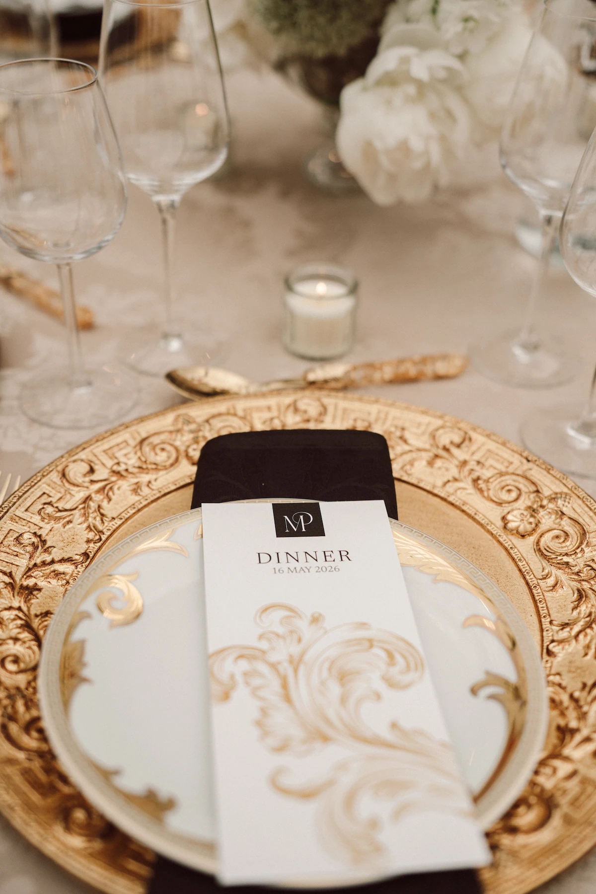 A gold-rimmed place setting with a menu card