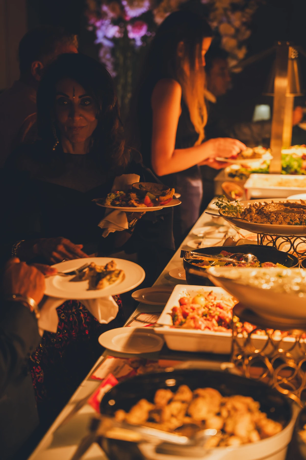 Guests helping themselves at a buffet station