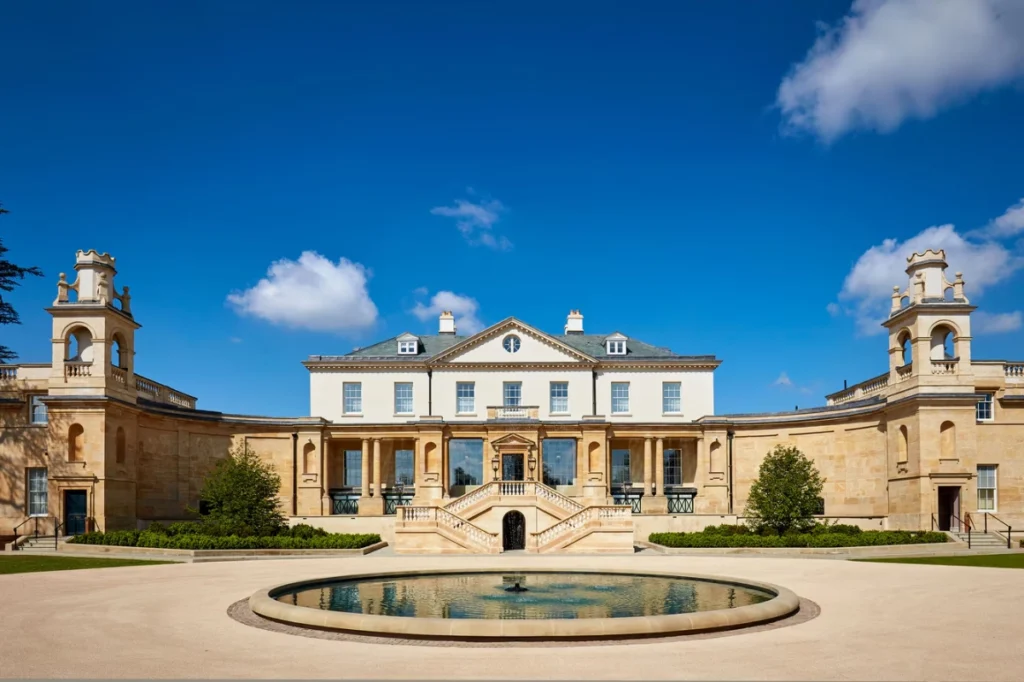 The Langley in Buckinghamshire – a Georgian mansion with curved stone wings and a twin staircase, seen across its fountain courtyard